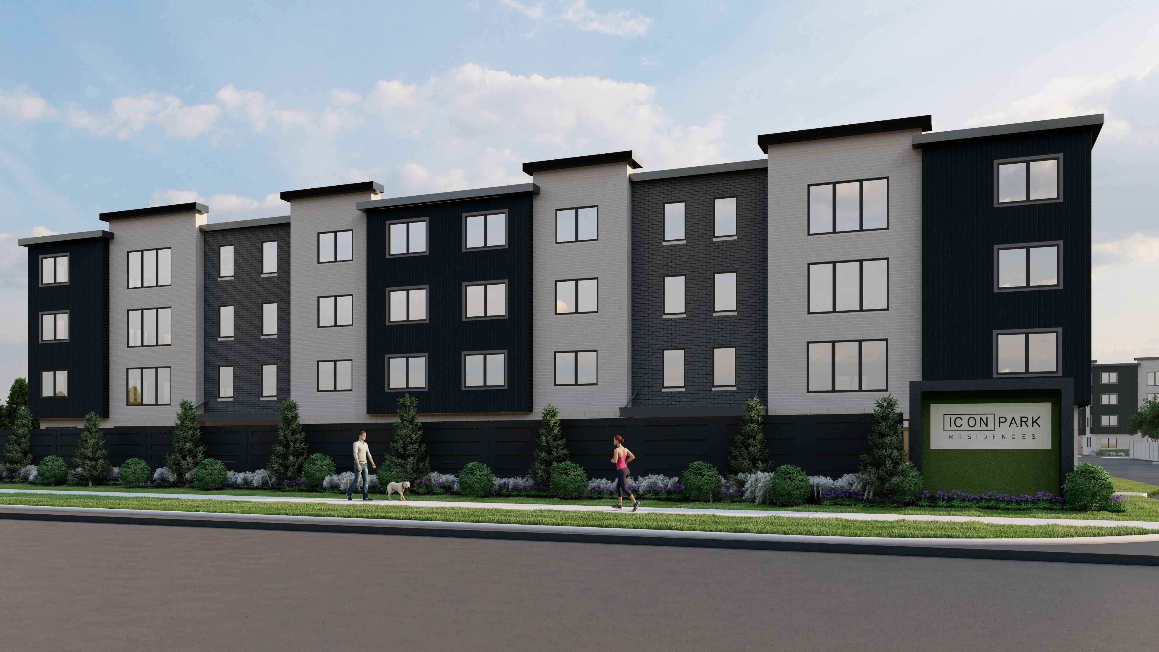 A row of modern townhouses with a woman walking a dog in front.